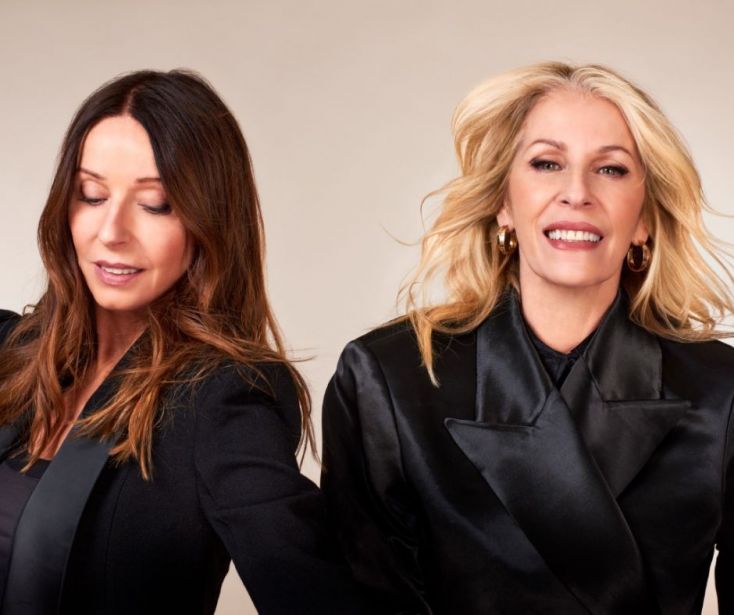 Two members of Bananarama smile at the camera.