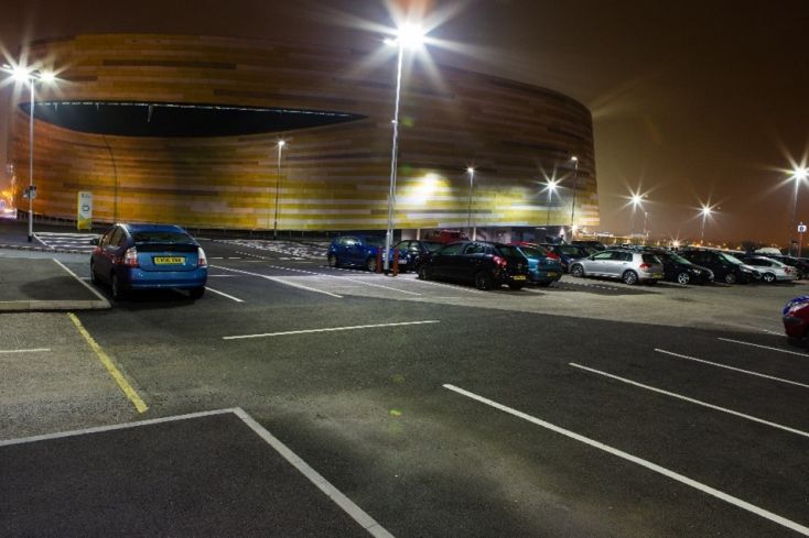 A picture of a car park at night with Derby Arena in the background.