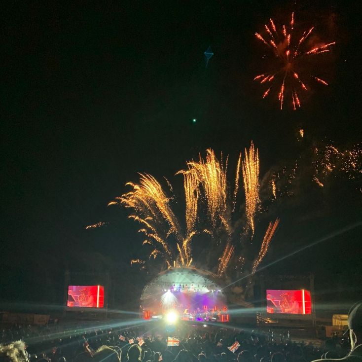 Fireworks sparkling over a outdoor concert