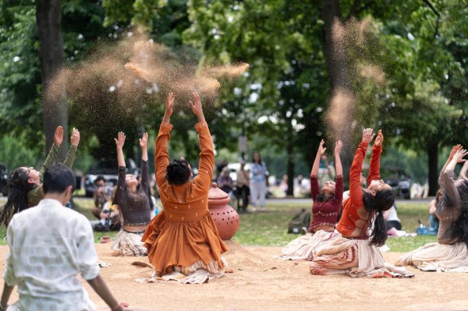 Performers dancing on sand
