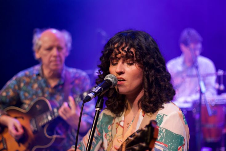 A lady sings into a microphone.