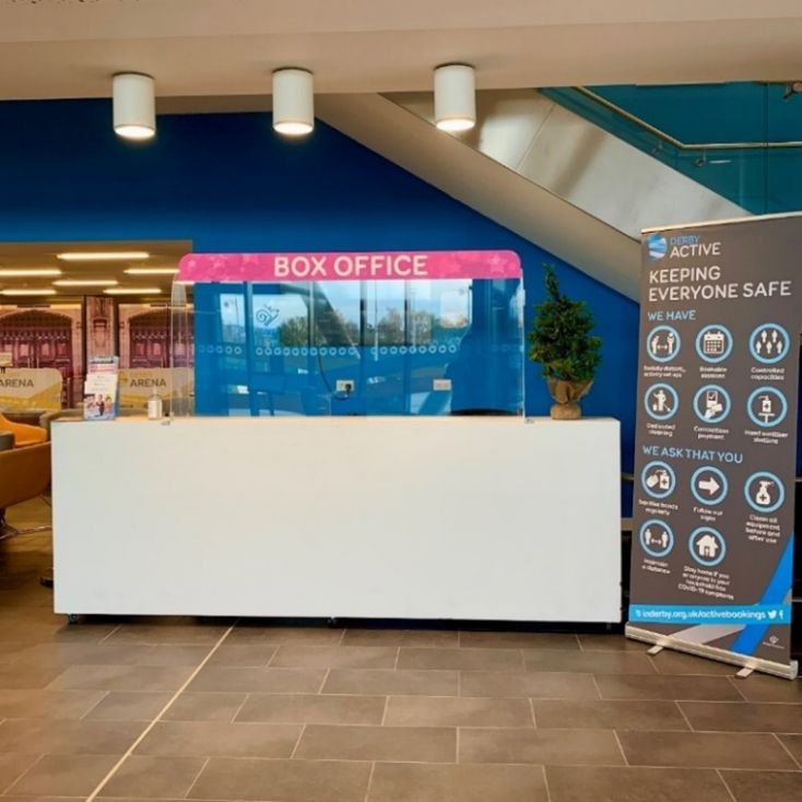 A picture of a white desk with a sign saying Box Office above.