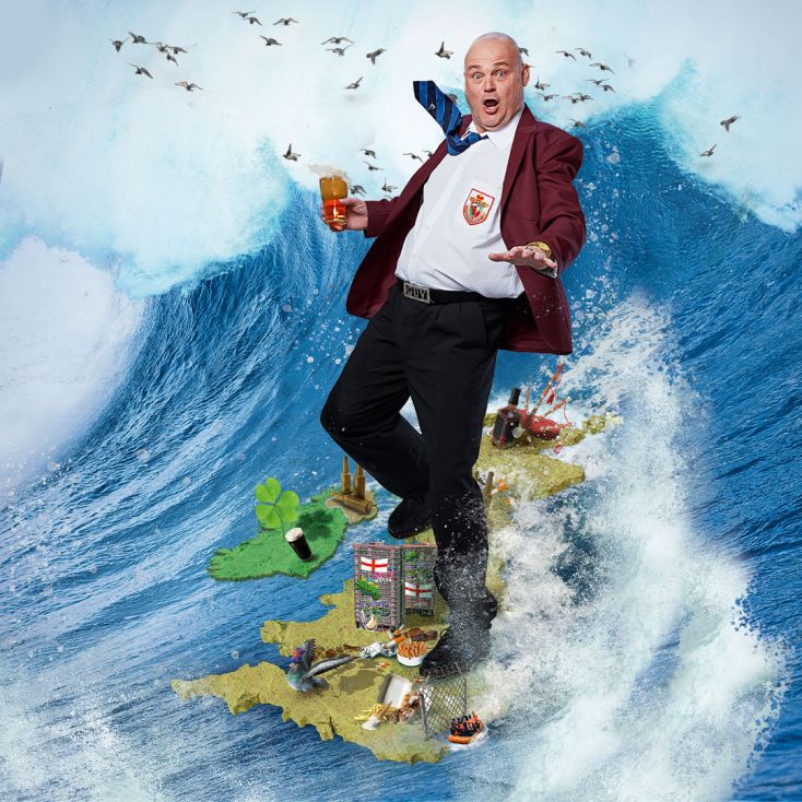 Al Murray is surfing on a model of the United Kingdom with a pint in hand