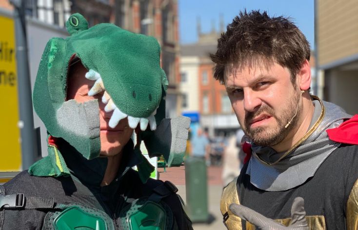 Men dressed as St George and a Dragon in a re-enactment of the legend