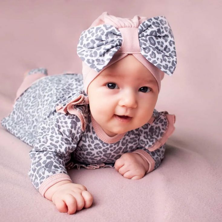 Baby with body suit and headband