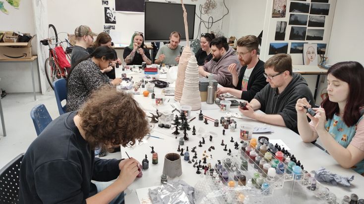 Volunteers from the Derbye Dungeons and Dragons project sitting at a table working on the game.