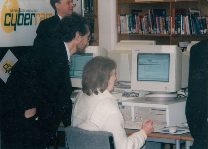 women and man on a computer desk system