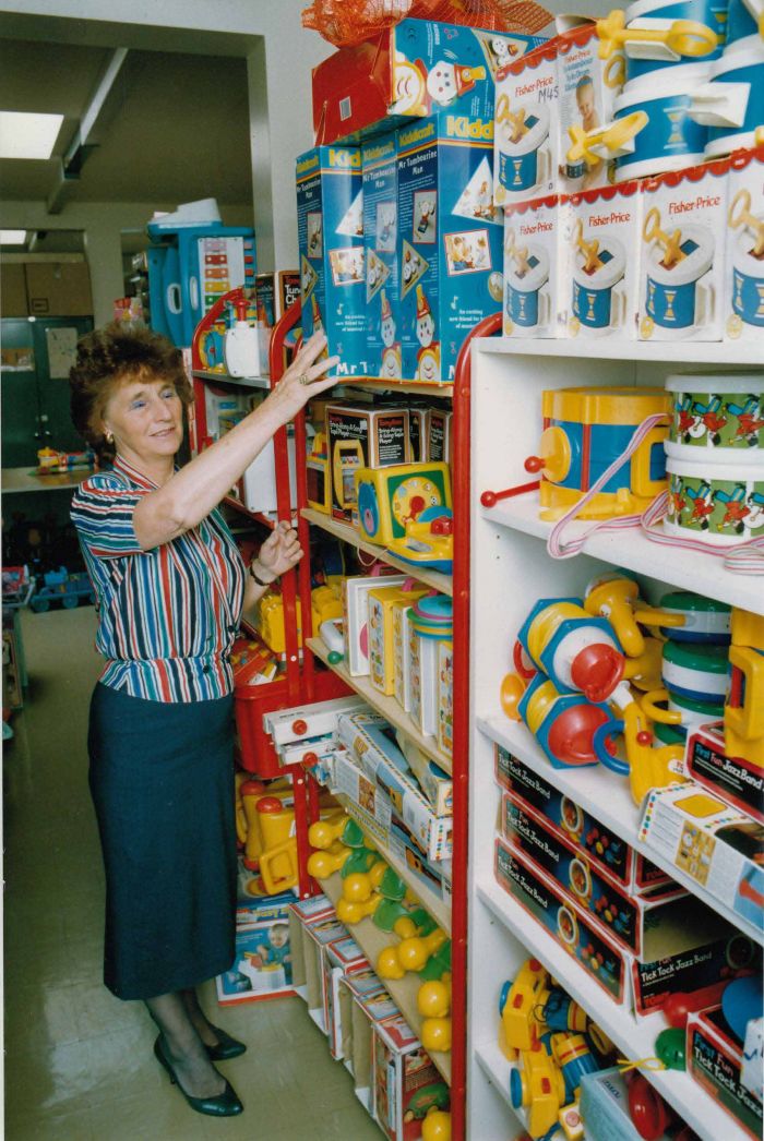 women in toy library arranging all the toys on the shelfs
